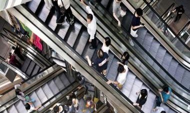 Watch: Woman knocked off escalator after being hit by falling suitcase