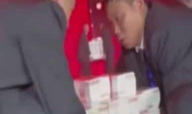 Chinese company piles $9 million to give staff bonuses, video of cash 'mountain' goes viral