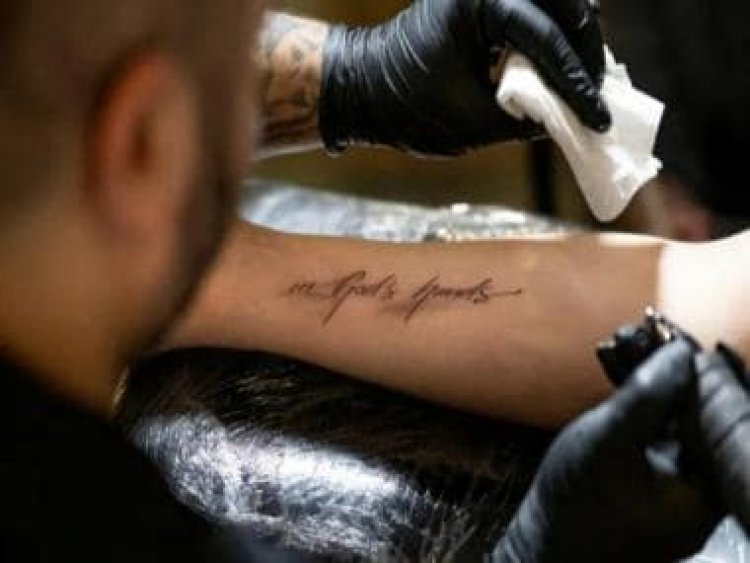 'In god's hands': Catholics assemble in numbers at Austrian church for 'free' tattoo