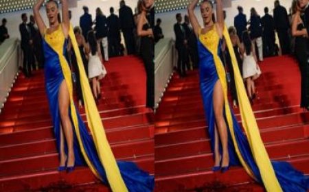 Woman draped in colours of the Ukrainian flag pours fake blood on herself at Cannes red carpet