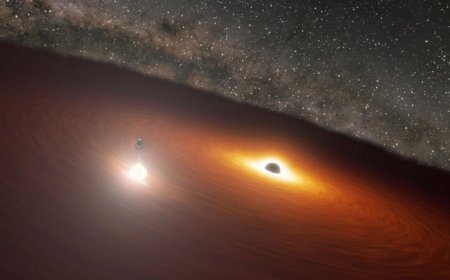A supermassive black hole orbiting a bigger one revealed itself with a flash