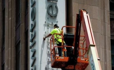 Twitter staff trying to remove the older logo from their building get detained by the police